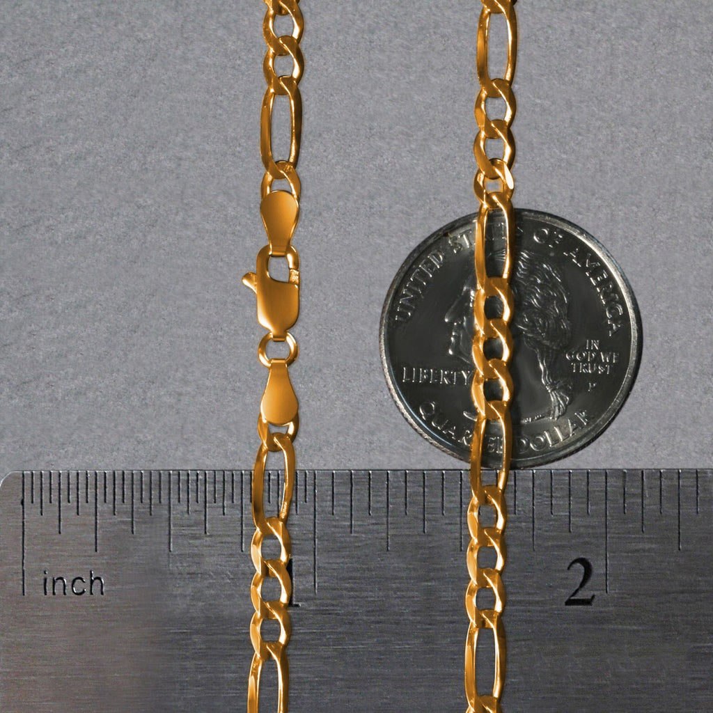 14K yellow gold solid Figaro chain, 3.80mm, shown flat on a quarter and ruler to display true scale, polished long‑and‑short links, and solid gold craftsmanship.