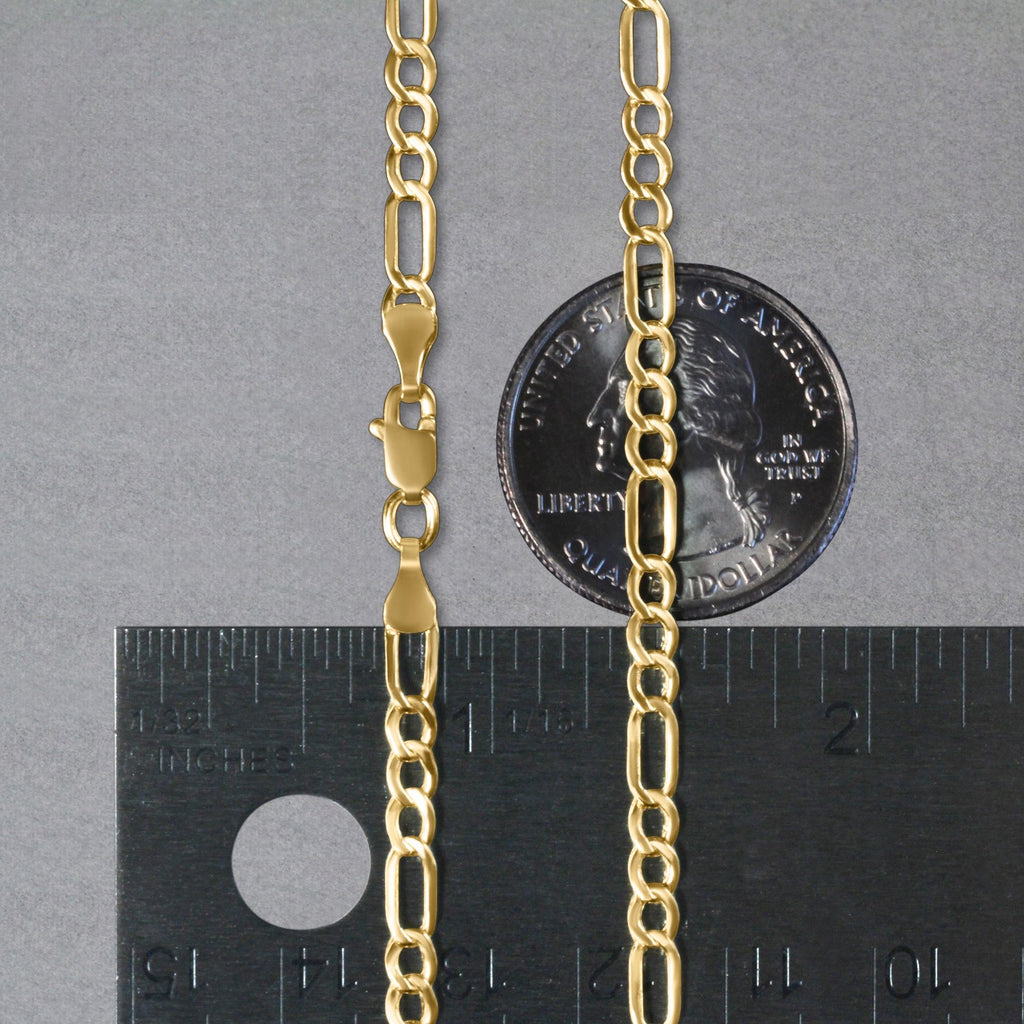 Coiled presentation of 10K yellow gold lite Figaro chain, 3.70mm, showing flexibility and polished shine.