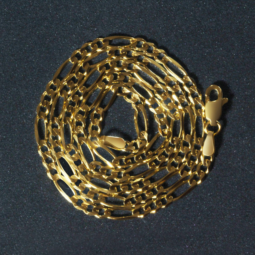 10K yellow gold solid Figaro chain, 2.60mm, wrapped in a circular coil to highlight polished links and solid gold craftsmanship.